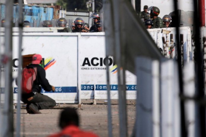 Demonstrators are seen during a clash with Venezuela's security forces at Simon Bolivar cross-border bridge between Venezuela and Colombia as seen from Cucuta