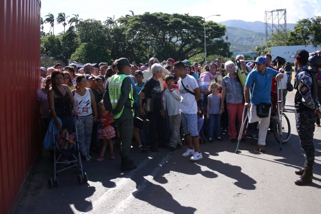 People wait to cross the Colombian-Venezuelan border over the partially opened Simon Bolivar international bridge in San Antonio del Tachira